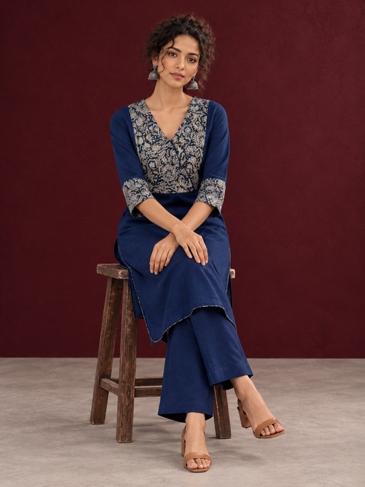 Elegant Navy Blue Kurta with Contrast Kalamkari Print Yoke and Matching Sleeve Cuffs — seated