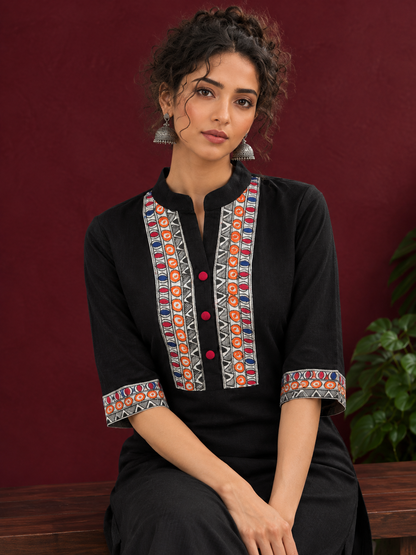 Classic Black Cotton Kurta with hand painted Madhubani neck panels & Matching Sleeve Cuffs — seated detail