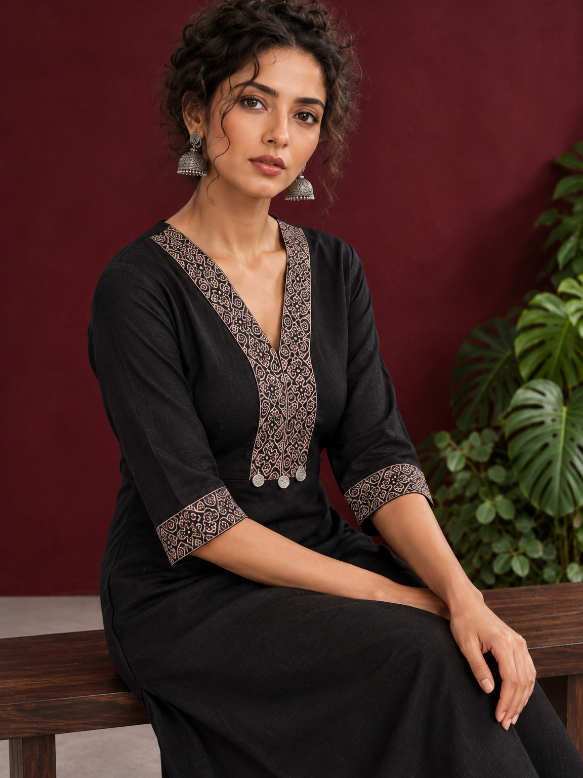 Timeless Black Cotton Kurta with Contrast Beige Ajrakh Printed V-Neck Panel & Matching Sleeve Cuffs — seated detail — view 6