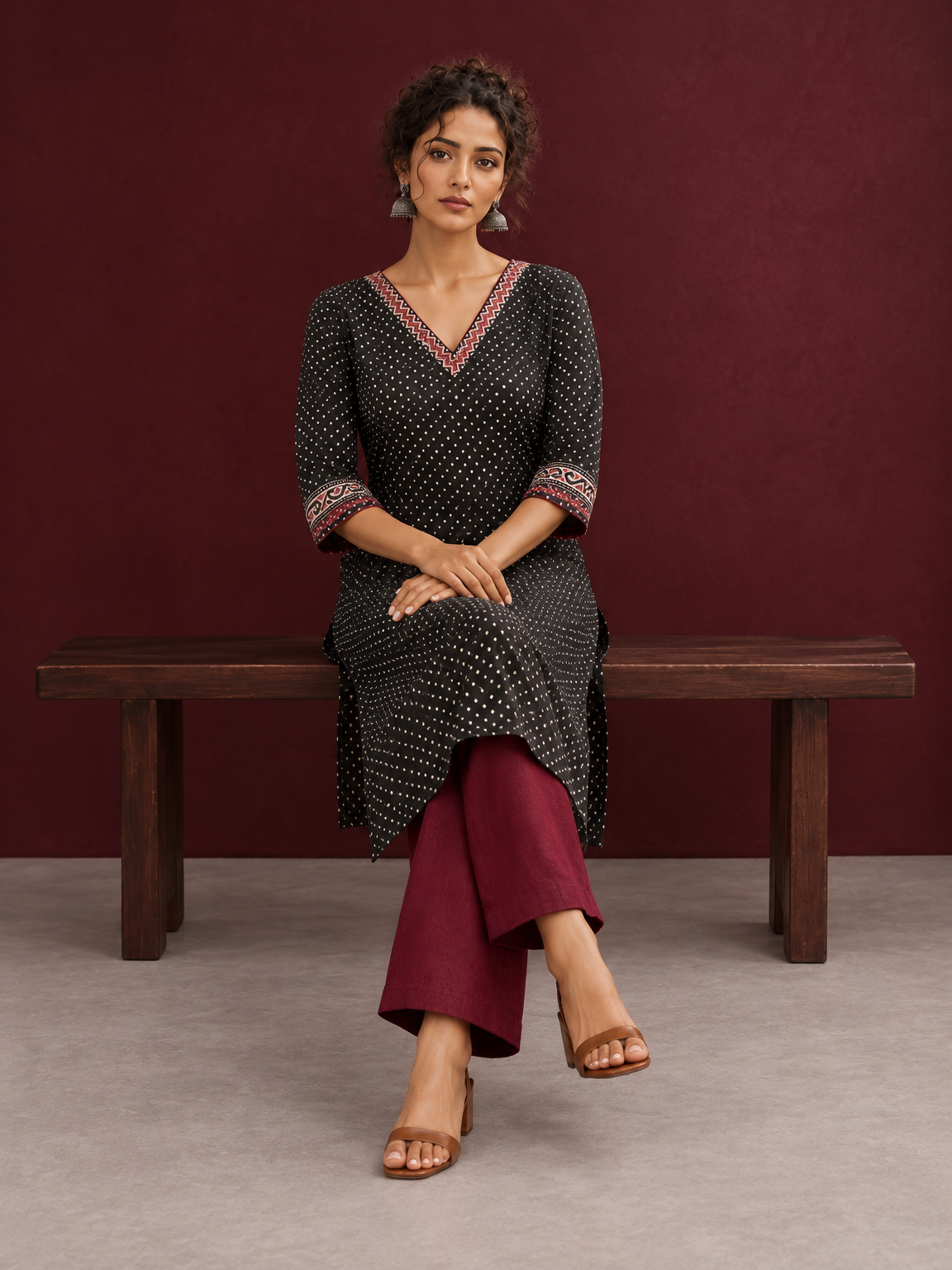 Classic Black Polka Dot Kurta with Contrast Zig-Zag Ajrakh V-Neck With Ajrakh Border On Cuffs — seated — view 5