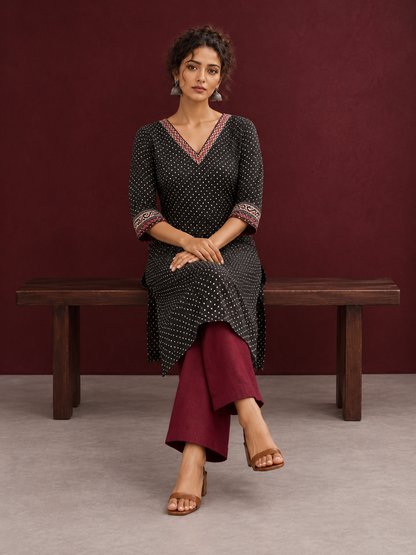 Classic Black Polka Dot Kurta with Contrast Zig-Zag Ajrakh V-Neck With Ajrakh Border On Cuffs — seated