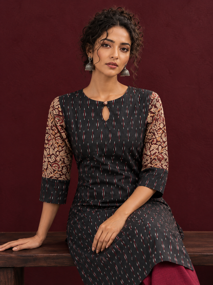 Timeless Black Ikat Cotton Kurta with Contrast Kalamkari Print Sleeves & Keyhole Neckline — seated detail