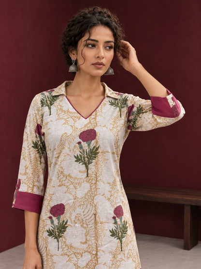 Ivory floral printed kurta with pink and green flowers, a V-neck, and contrasting pink cuffs. — styled view