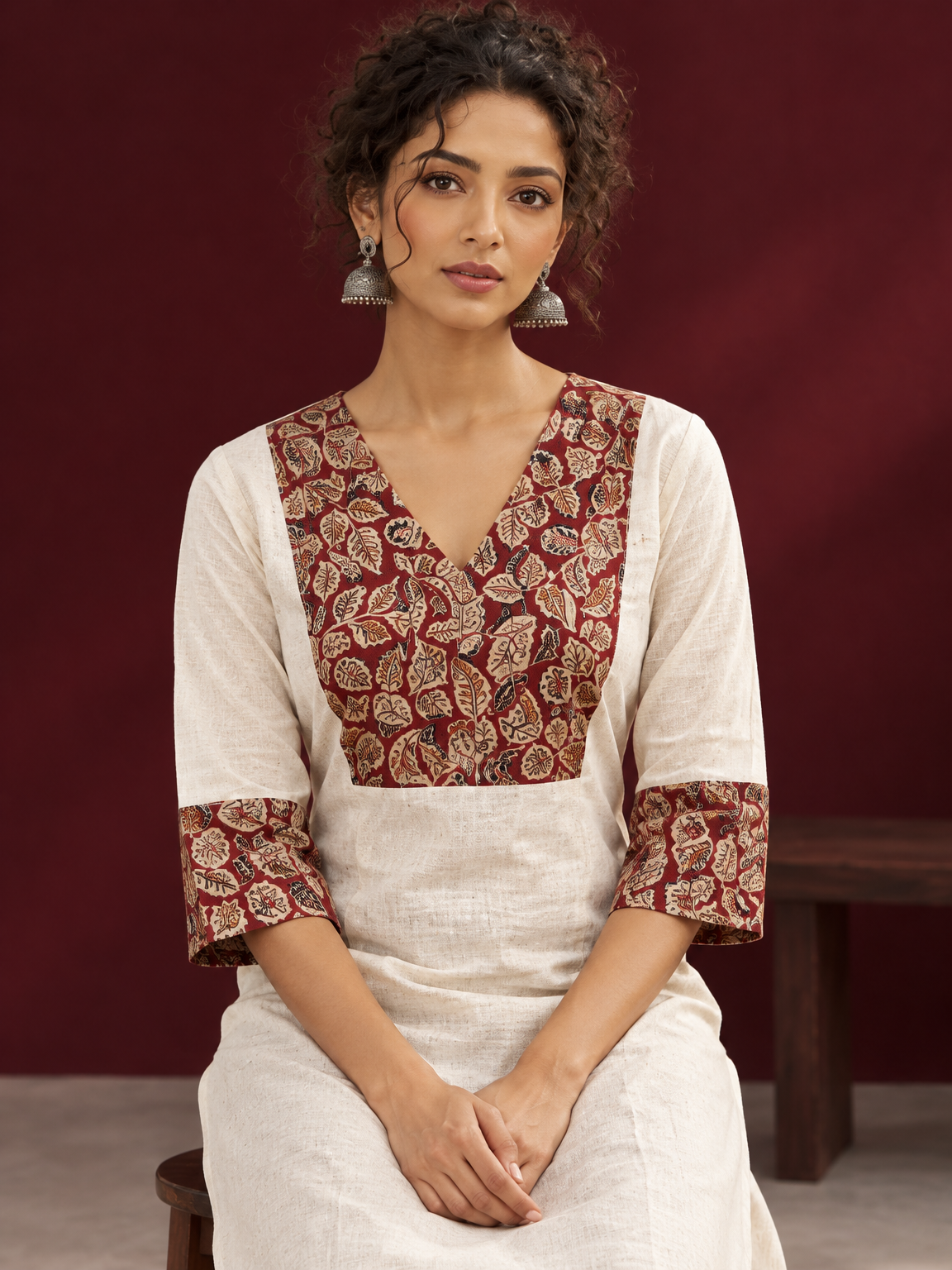 Elegant Off-White Cotton Kurta with Kalamkari Leaf Print Yoke and Contrast Cuffs — seated detail — view 5