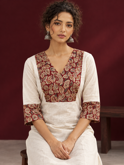 Elegant Off-White Cotton Kurta with Kalamkari Leaf Print Yoke and Contrast Cuffs — seated detail