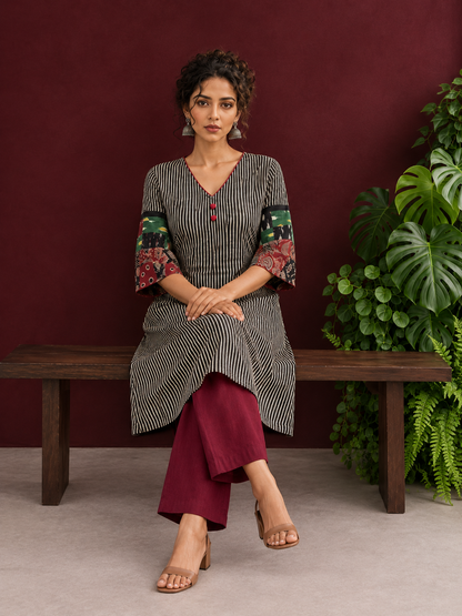 Timeless Black and Off-White Striped Cotton Ajrakh Kurta with Multicolor Patchwork Sleeve Panels — seated