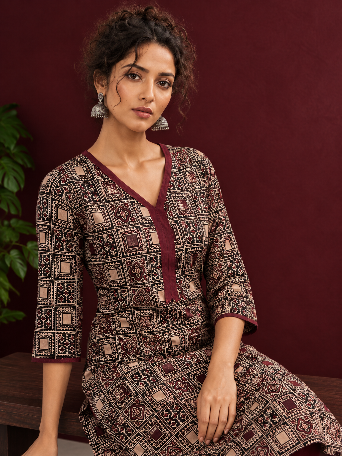 Timeless Black Ajrakh Print Cotton Kurta with Maroon V-Neck — seated detail — view 6