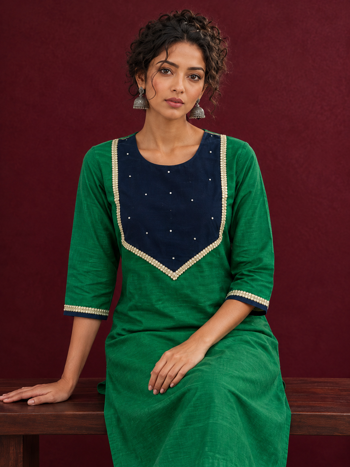Elegant Green Silk Kurta with Contrast Navy Blue Yoke Panel, Sequin Embellishment & Gota Trim — seated detail — view 7