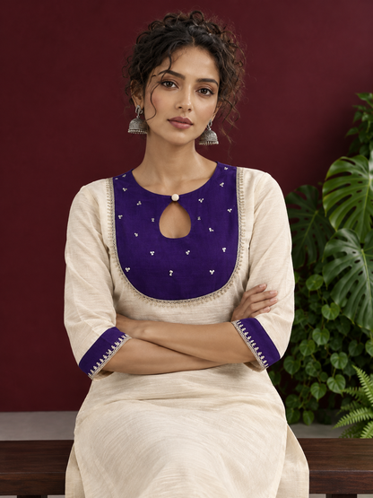 Elegant Off-White Silk Kurta with Contrast Purple Yoke Panel & Hand Embroidered Sequin Detailing — seated detail