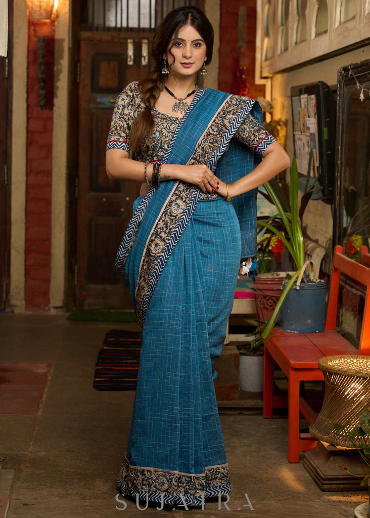 Exclusive Teal blue cotton saree highlighted with kalamkari and indigo borders