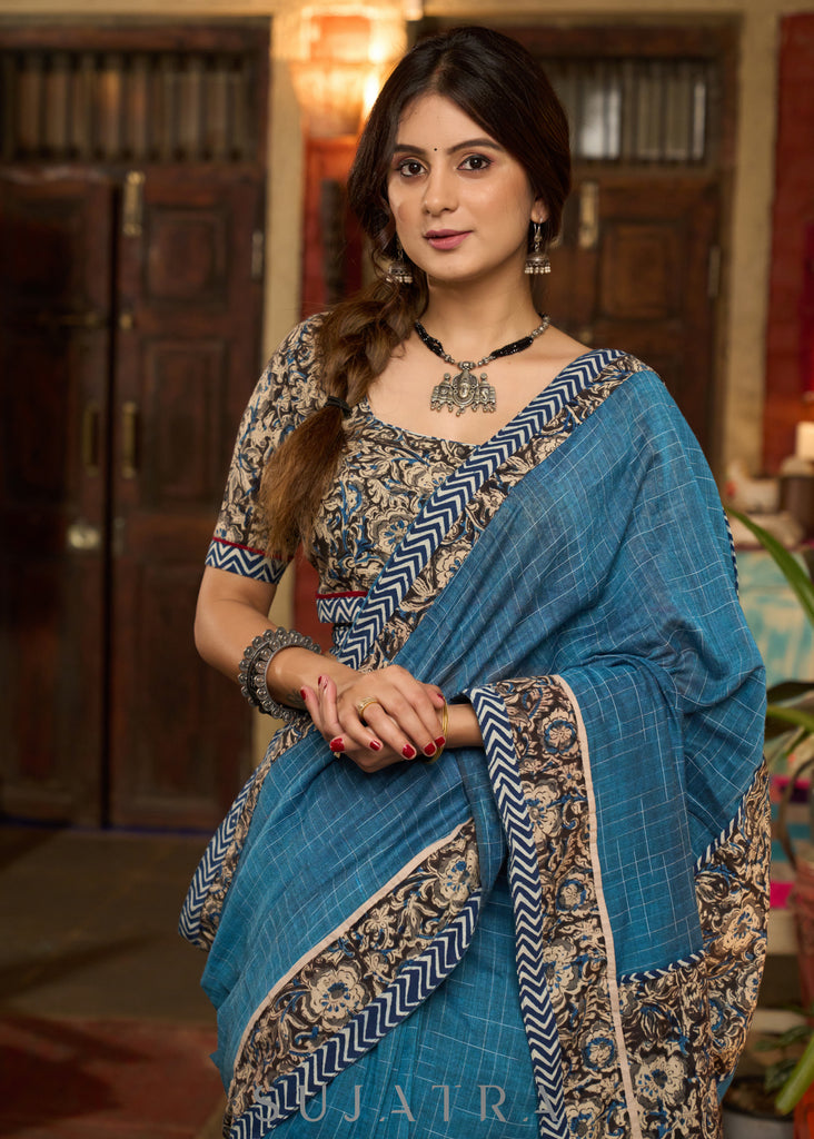 Exclusive Teal blue cotton saree highlighted with kalamkari and indigo borders