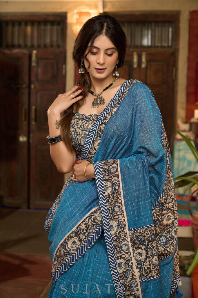 Exclusive Teal blue cotton saree highlighted with kalamkari and indigo borders