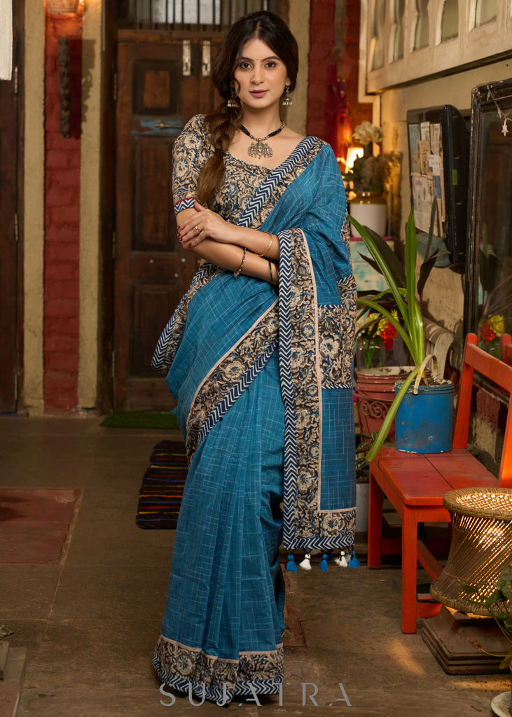 Exclusive Teal blue cotton saree highlighted with kalamkari and indigo borders