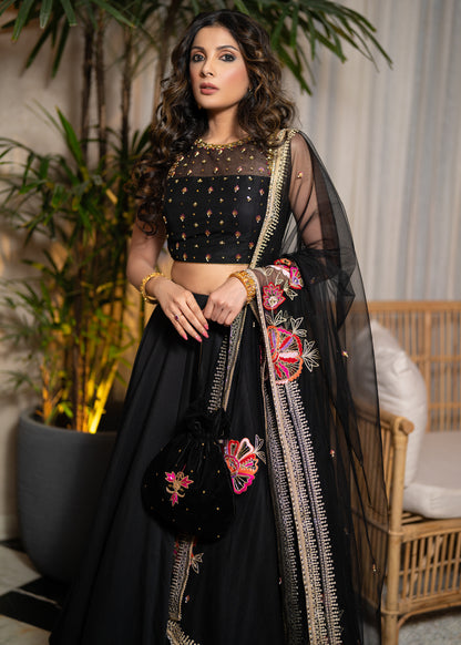 Classic Black Cotton Silk Lehenga paired with delicately embellished net dupatta accentuated with heavy floral embroidery and hand embellishments