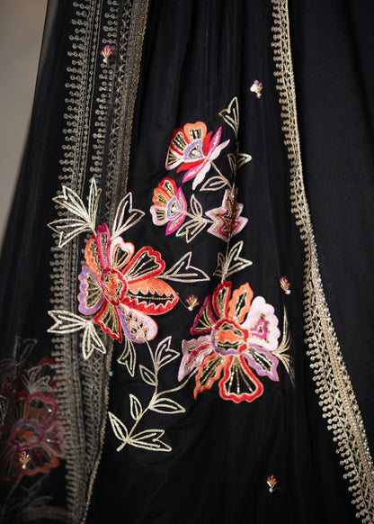 Classic Black Cotton Silk Lehenga paired with delicately embellished net dupatta accentuated with heavy floral embroidery and hand embellishments