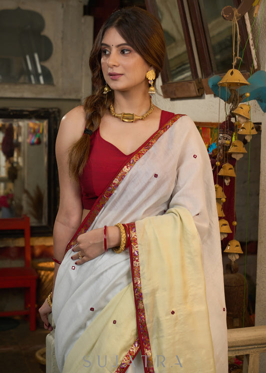 Elegant silver & golden linen half and half saree highlighted with contrast mirror work