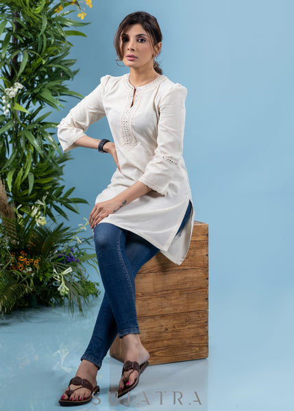 Subtle pearl white cotton tunic highlighted with matching mirror lace