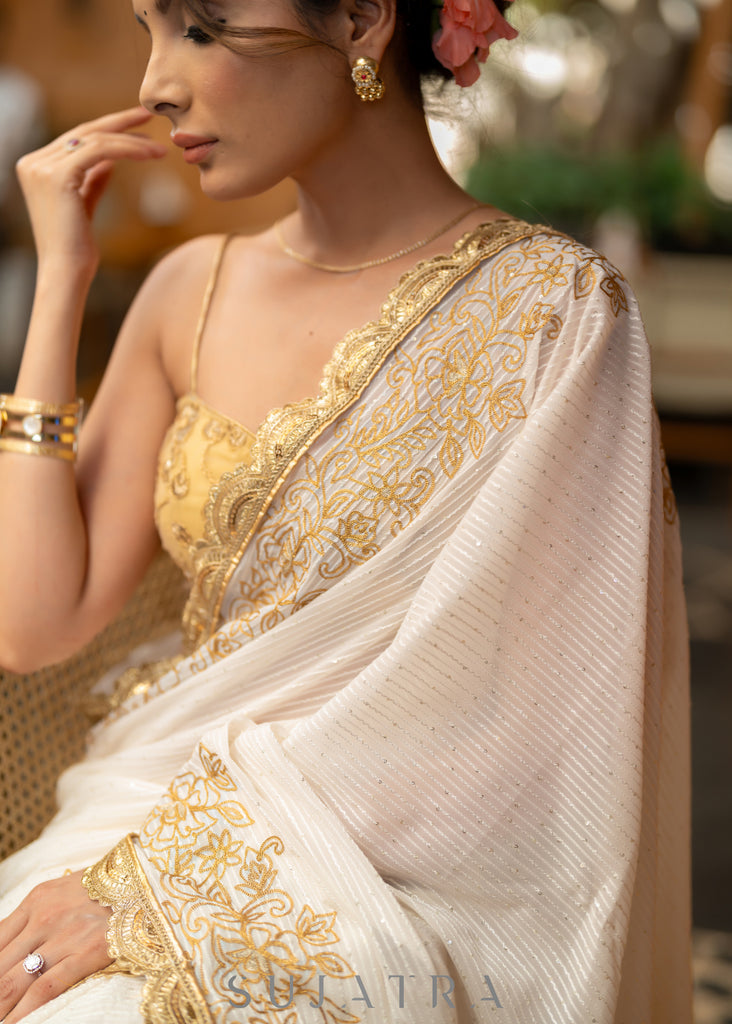 Subtle White Georgette Saree With Beautiful Sequenced Crochet Highlighted With Intricate Floral Embroidery And Scalloped Lace
