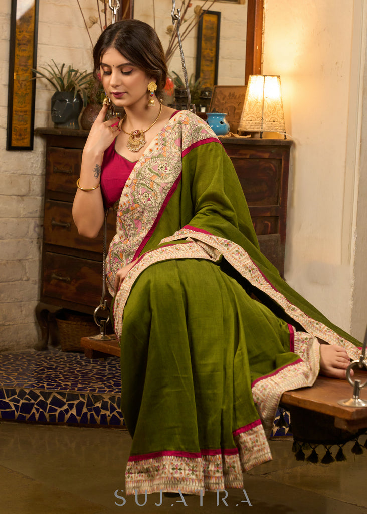 Elegant moss green cotton saree highlighted with handpainted madhubani