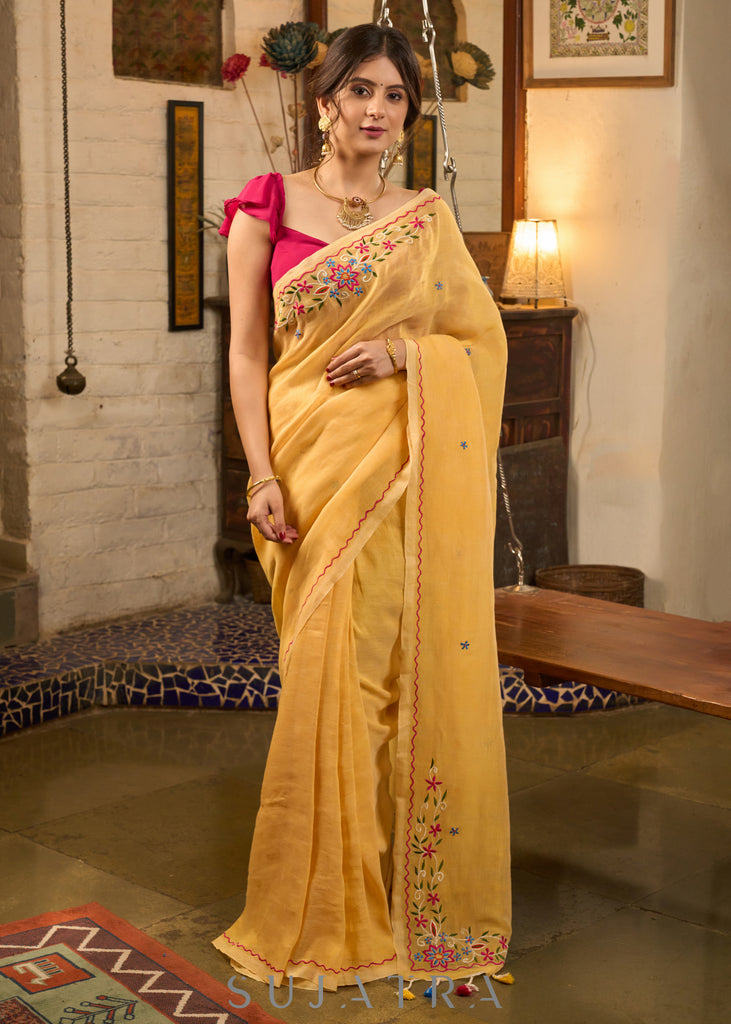 Beautiful yellow cotton saree highlighted with multicolor floral embroidery