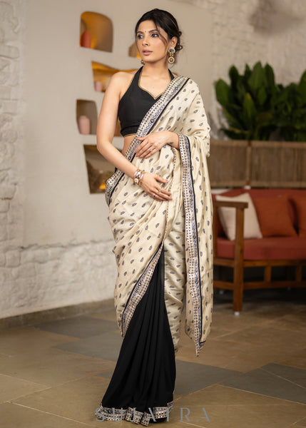 Elegant Light Beige Cotton Silk Saree With Black Georgette Combination Highlighted With Beautiful Floral Embroidery And Contrast Lace