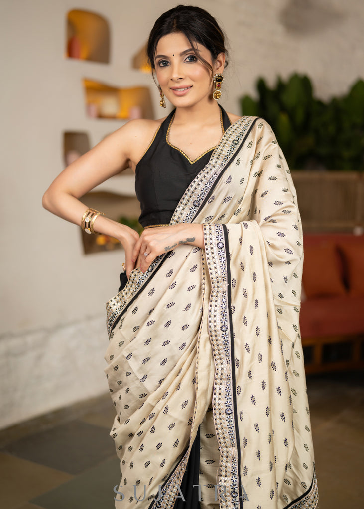 Elegant Light Beige Cotton Silk Saree With Black Georgette Combination Highlighted With Beautiful Floral Embroidery And Contrast Lace