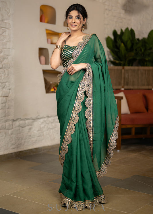 Graceful Bottle Green Organza Saree Highlighted With Matching Scalloped Lace
