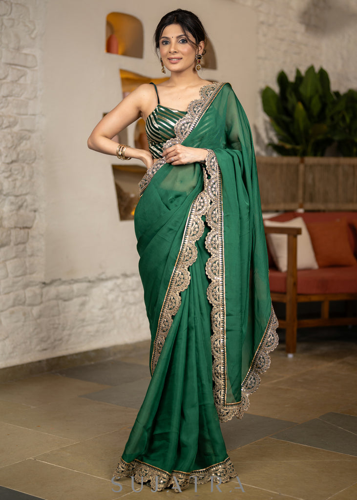 Graceful Bottle Green Organza Saree Highlighted With Matching Scalloped Lace