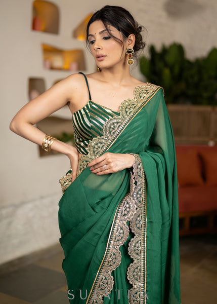 Graceful Bottle Green Organza Saree Highlighted With Matching Scalloped Lace