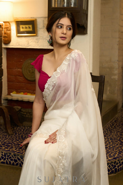 Graceful ivory organza saree with elegant floral embroidery on the border