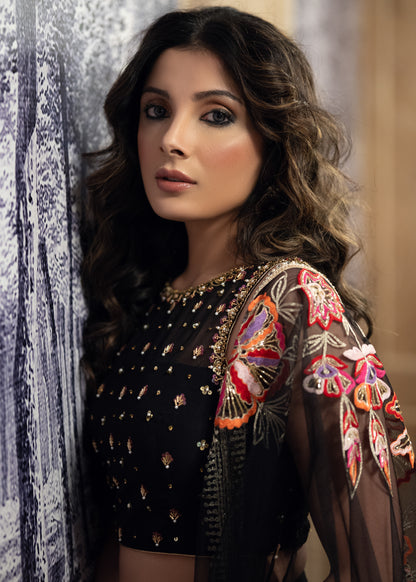 Classic Black Cotton Silk Lehenga paired with delicately embellished net dupatta accentuated with heavy floral embroidery and hand embellishments