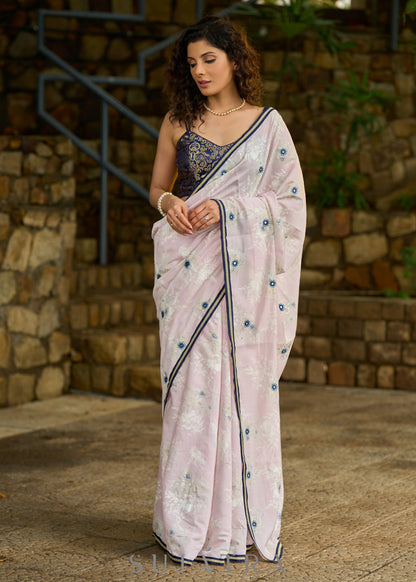 Subtle light pink floral embroidered saree highlighted with overall mirror embroidery and golden lace