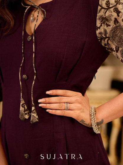 Playful purple cotton dress showcasing floral puff sleeves and box pleats released from the dart for soft volume and flow