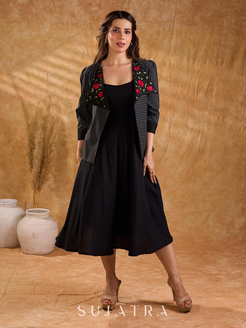 Exquisite black Ikat jacket with offset collar flaps and detailed red floral vine embroidery, delivering a sculpted, high-impact silhouette with refined presence for corporate styling.