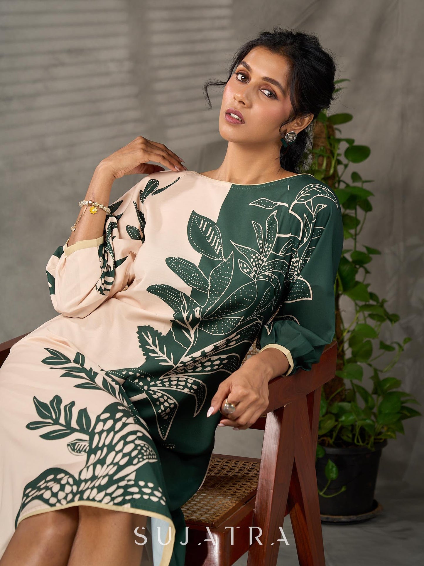 Bottle green and beige half and half dress with raglan sleeves and transitioning floral motifs.