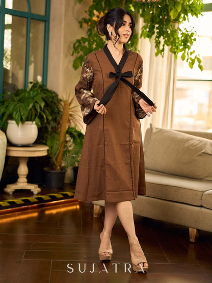 Brown block print dress with floral block printed flared sleeves, black tie-up neckline, and contrast black accents for an effortless, elegant everyday look.