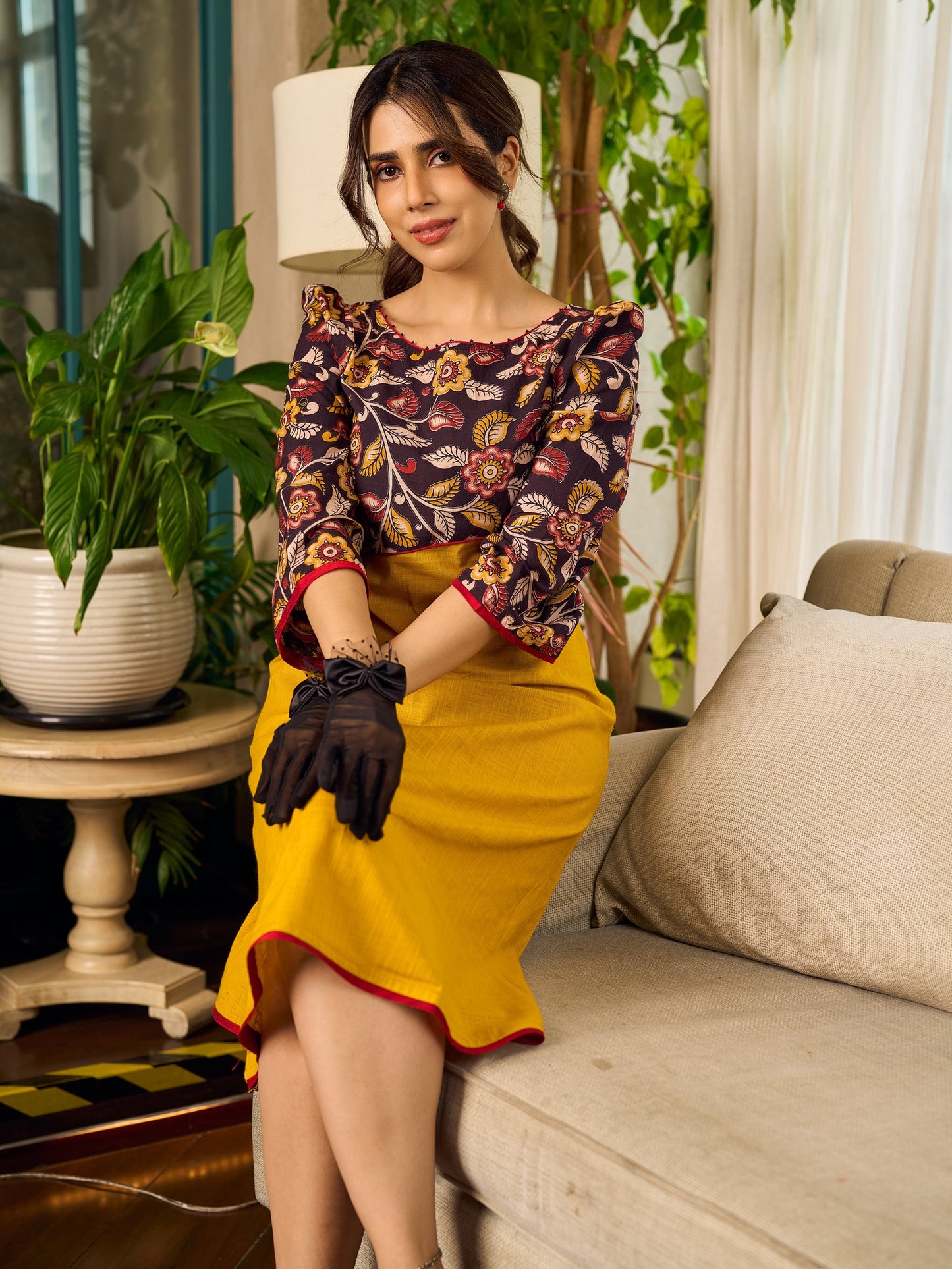 Mustard Kalamkari dress with an asymmetrical yoke and puffed sleeves.