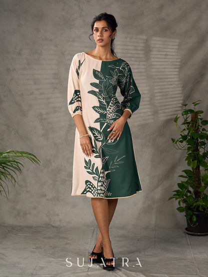 Bottle green and beige half and half dress with raglan sleeves and transitioning floral motifs.