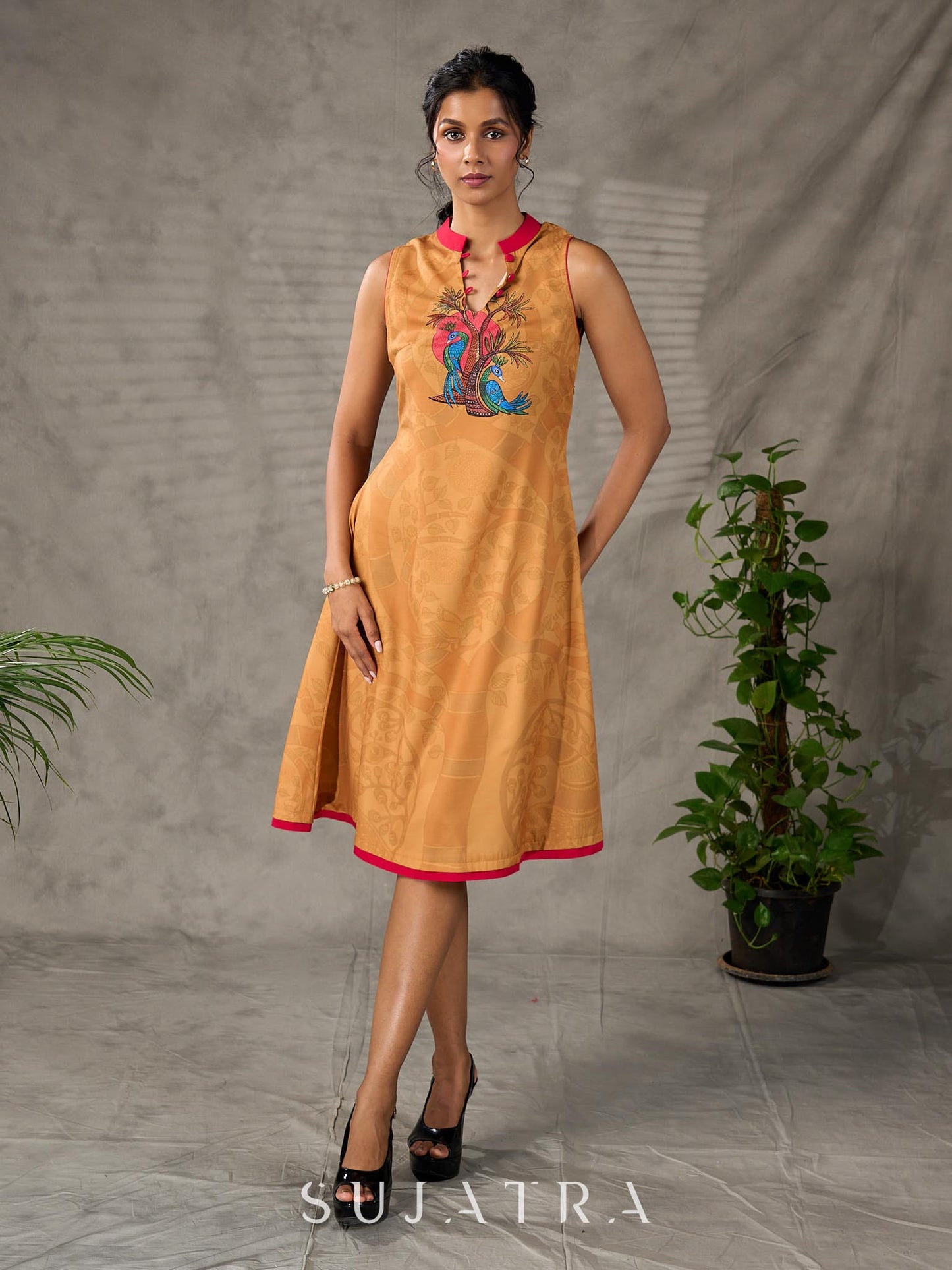 Mustard Gond printed mandarin collar dress with vibrant pink accents.