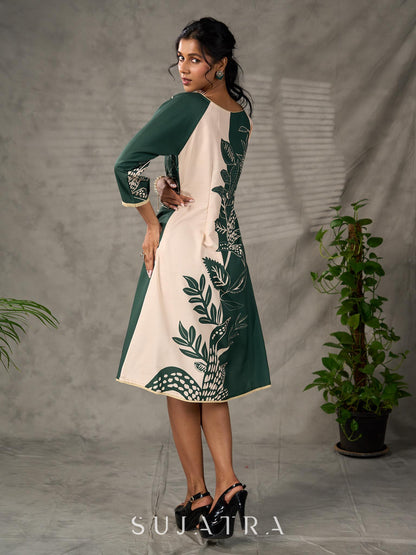 Bottle green and beige half and half dress with raglan sleeves and transitioning floral motifs.