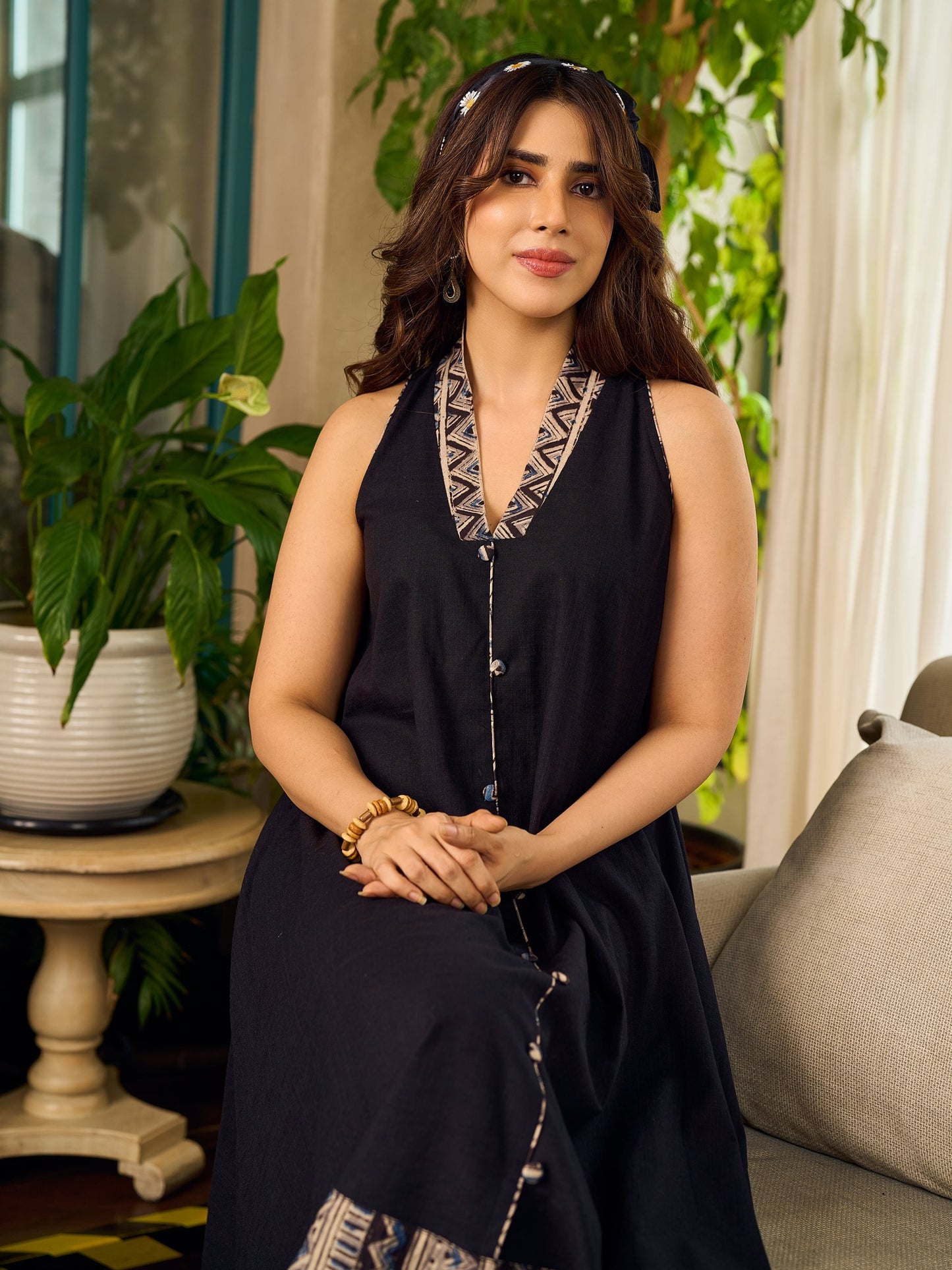 Modern black bias-cut dress showcasing unique artisan-inspired Kalamkari neck trim.