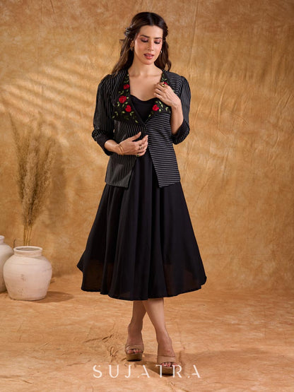 Exquisite black Ikat jacket with offset collar flaps and detailed red floral vine embroidery, delivering a sculpted, high-impact silhouette with refined presence for corporate styling.