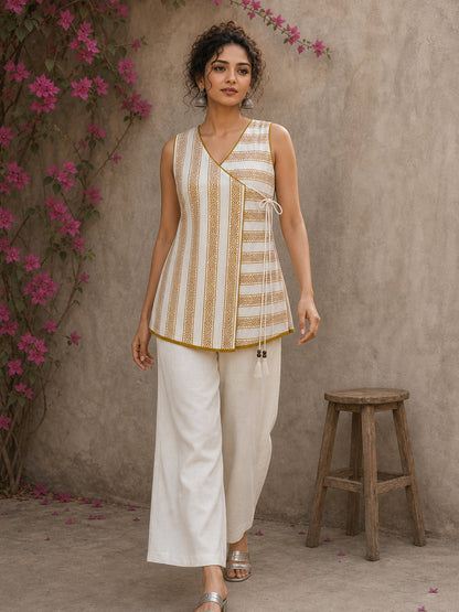 Charming white and mustard sleeveless wrap top featuring a distinctive Block print pattern, elegant mustard piping, and a graceful, contemporary, artisan-inspired tailored silhouette.