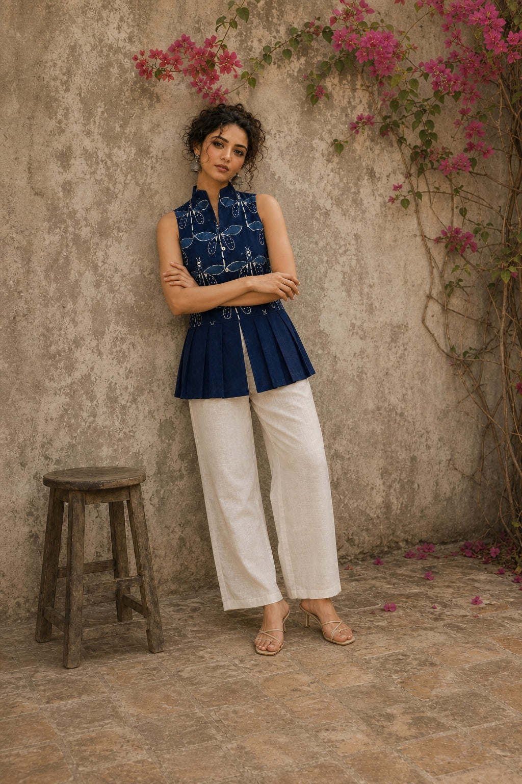 Contemporary indigo top with delicate dragonfly motifs, high folded collar, and graceful pleated hemline.