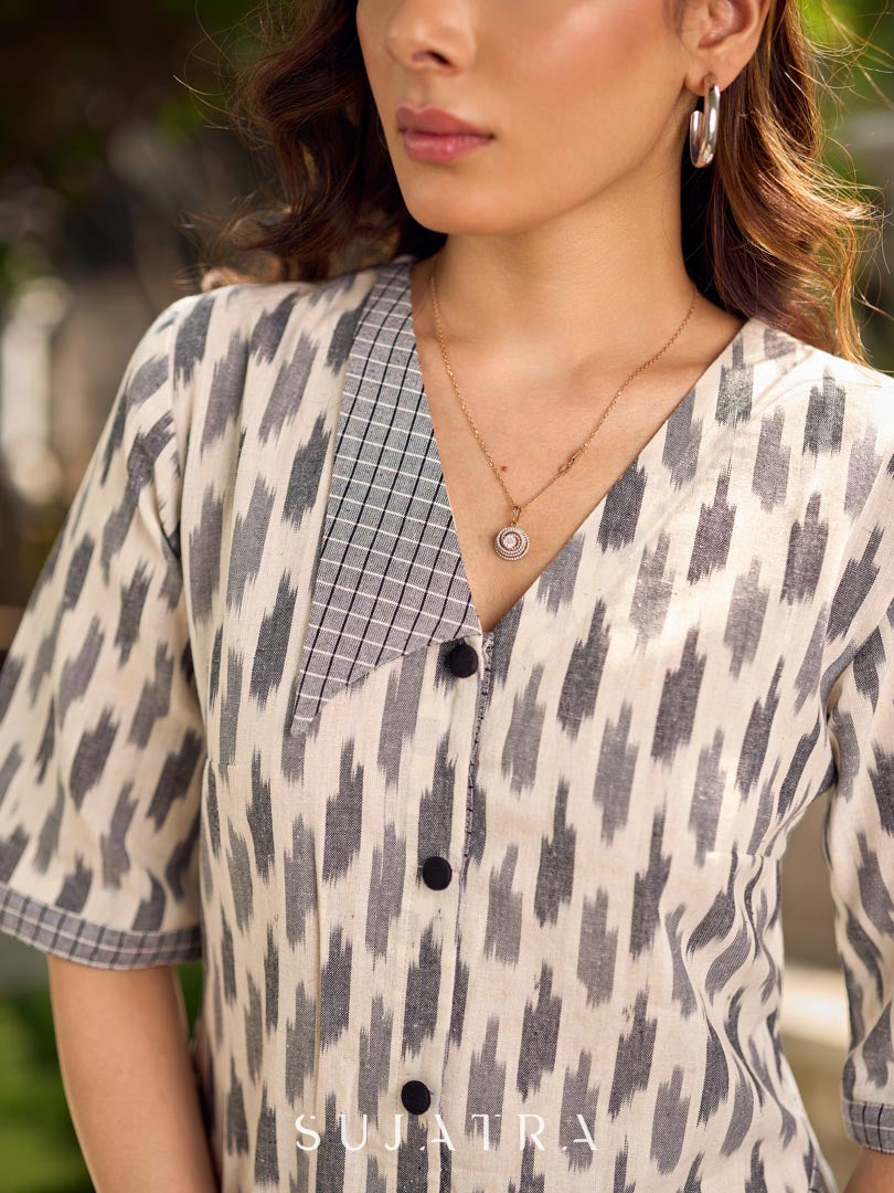 Modern white and grey Ikat shirt dress elevated with an asymmetrical checkered Ikat collar and contrast black accents.