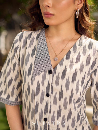 Modern white and grey Ikat shirt dress elevated with an asymmetrical checkered Ikat collar and contrast black accents.