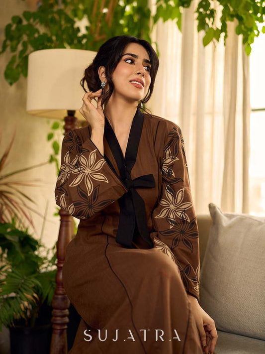 Brown block print dress with floral block printed flared sleeves, black tie-up neckline, and contrast black accents for an effortless, elegant everyday look.