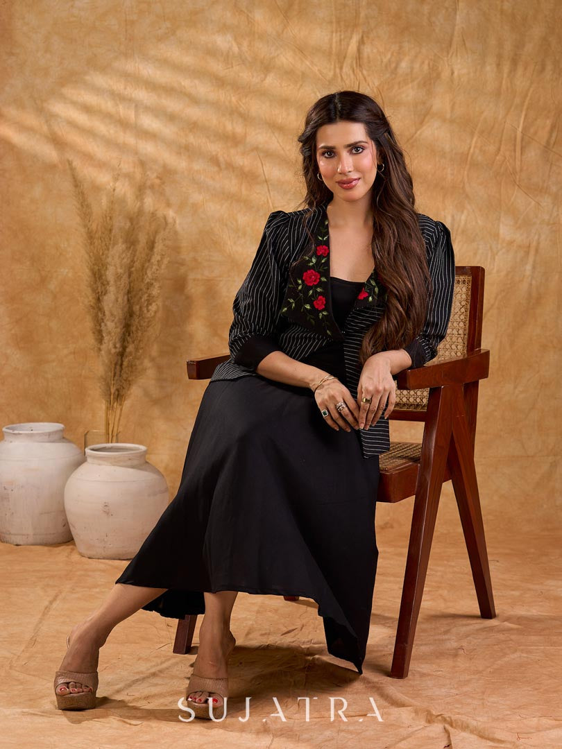 Exquisite black Ikat jacket with offset collar flaps and detailed red floral vine embroidery, delivering a sculpted, high-impact silhouette with refined presence for corporate styling.