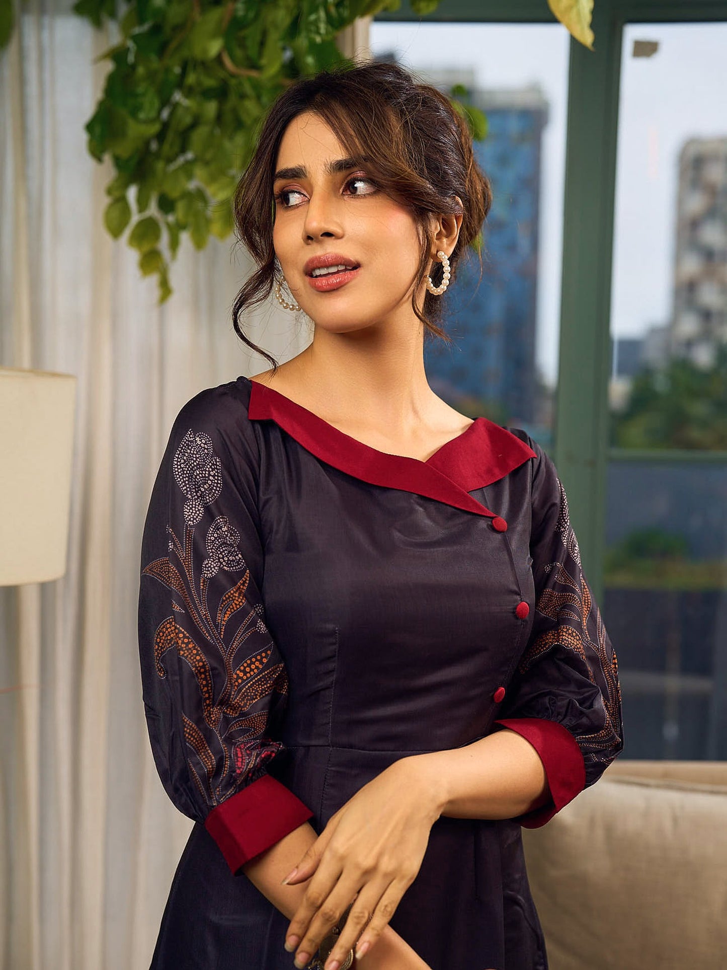 Elegant black Kalamkari-inspired dress with deep maroon accents and graceful floral motifs.