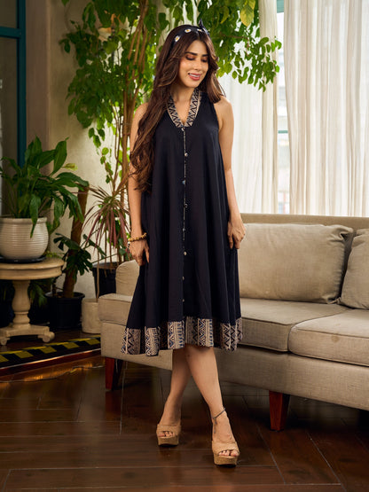 Modern black bias-cut dress showcasing unique artisan-inspired Kalamkari neck trim.